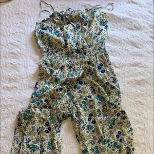 white jump suit with blue and yellow flowers